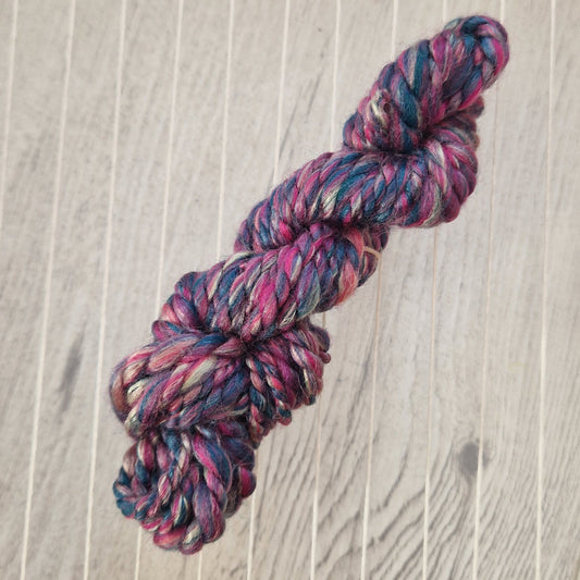 Multicolored skein of yarn on a wooden loom
